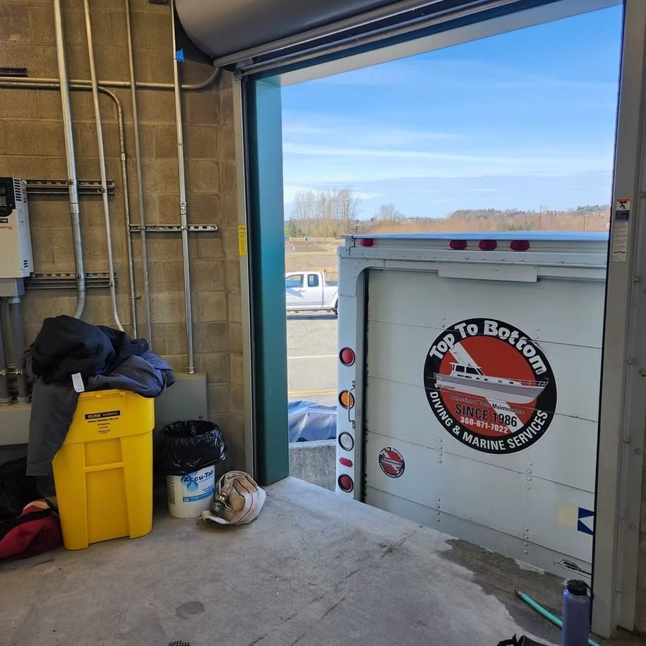 An open garage door with a sign that says top to bottom