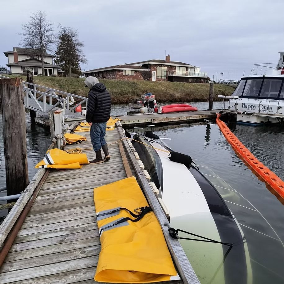 A man standing on a dock next to a boat that says ' paradise ' on it