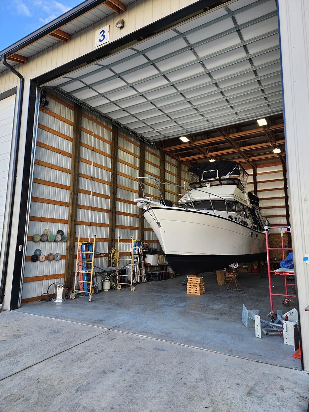 A large boat is sitting inside of a large building.
