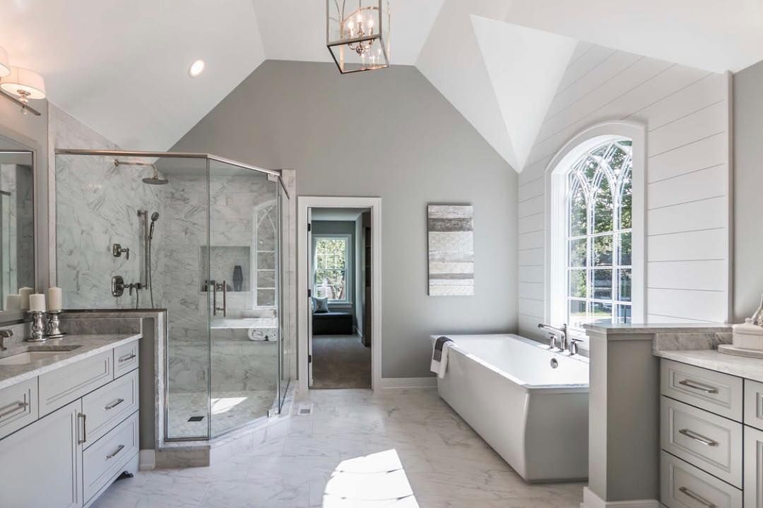Gray and white bathroom with a shower, bathtub, and vanity.