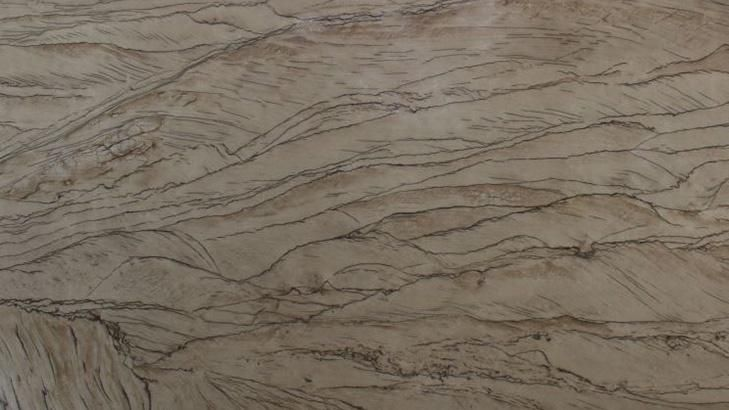 Tan-colored stone surface with wavy brown veining, resembling a landscape.