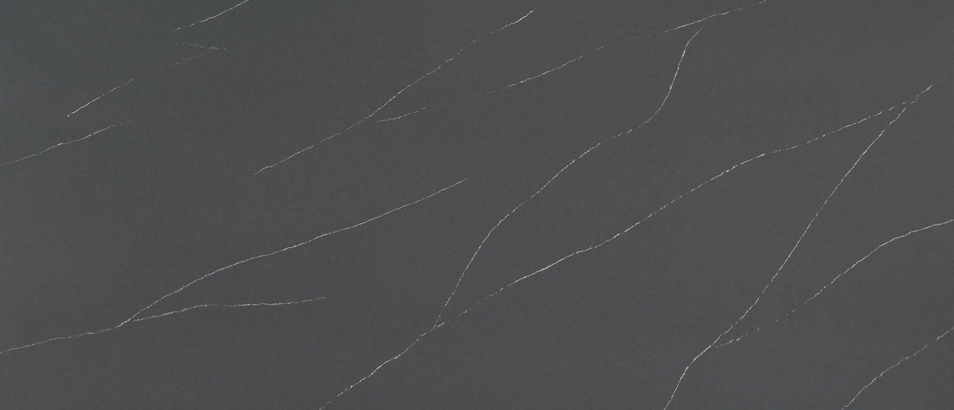 Dark gray surface with white veins.