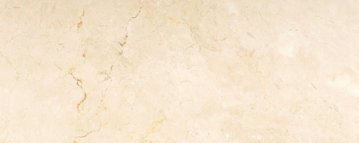 Cream-colored marble with subtle veining and texture.
