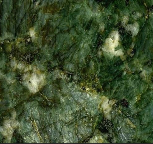 Close-up of vibrant green stone with white and dark veins running throughout.