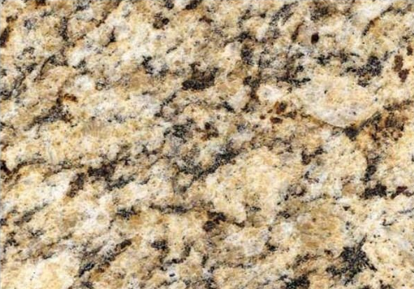 Close-up of a granite countertop with a speckled pattern in shades of beige, tan, and dark brown.