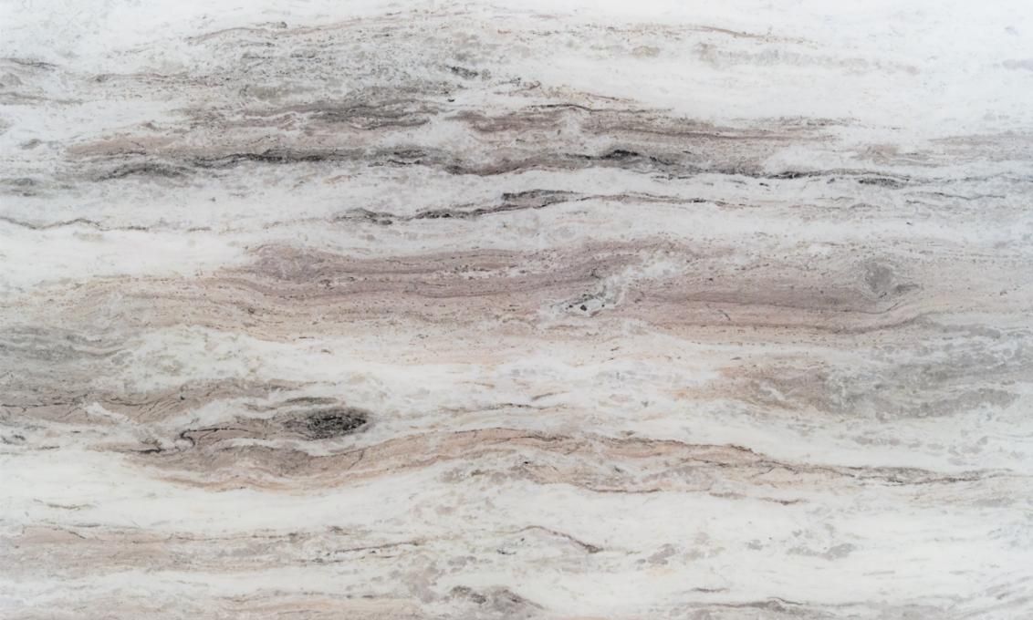 White and tan marble with swirling, linear patterns.