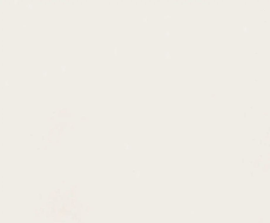 Off-white, textured surface with subtle variations in tone.