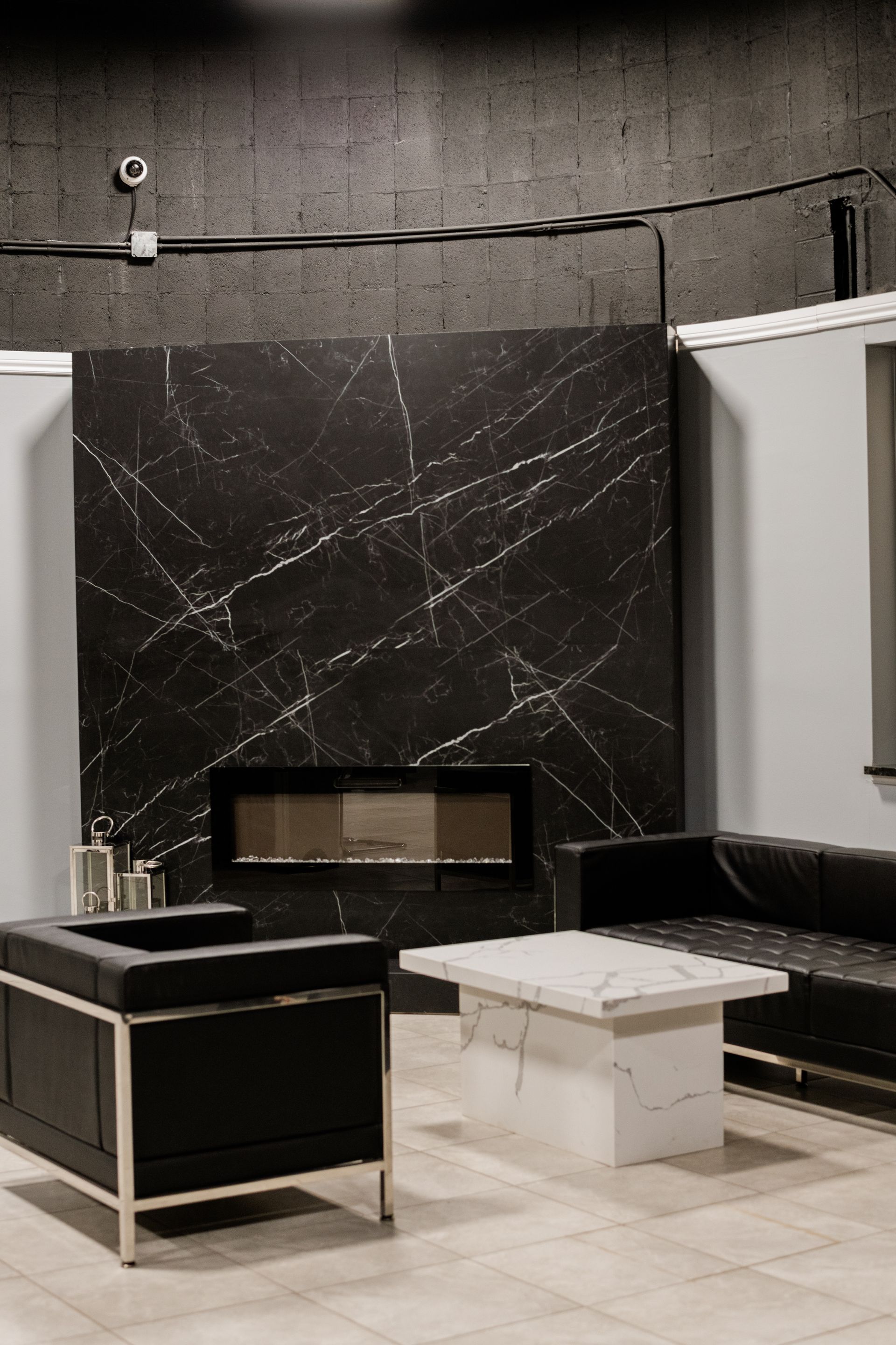 Waiting area with black marble fireplace