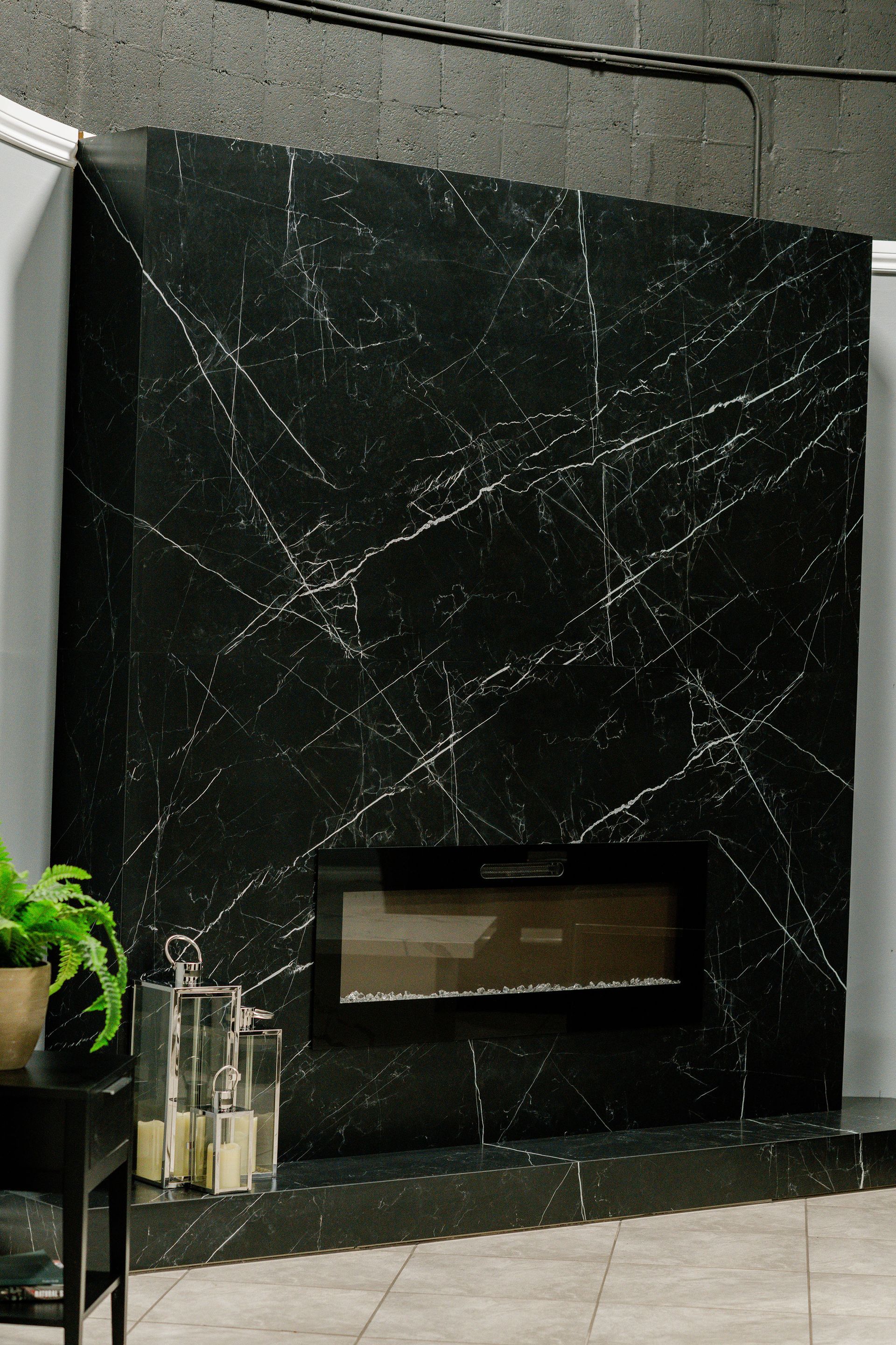 Black marble fireplace wall with a rectangular firebox