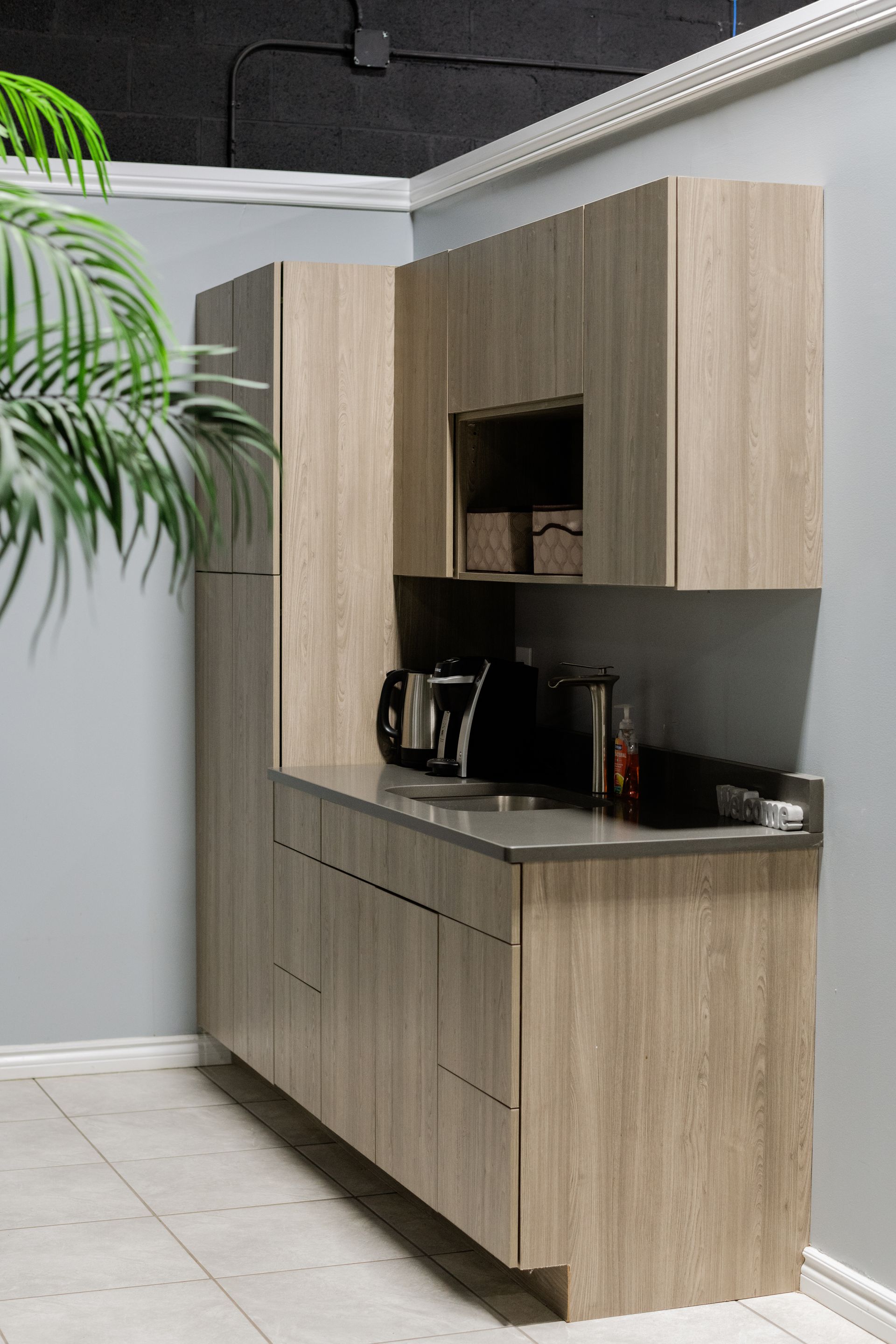 Modern wood kitchenette cabinet with countertop and built-in appliance niche 