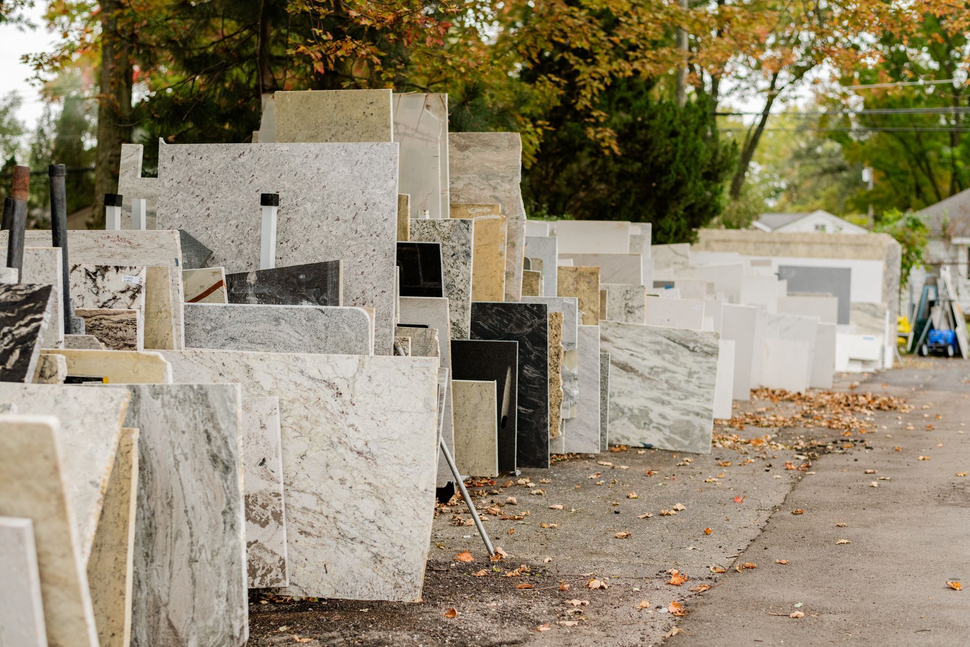 Rows of stone slabs displayed outdoors 
