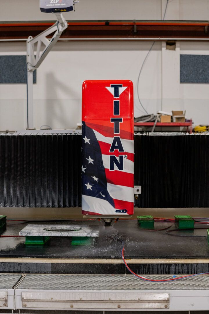 Red Titan trophy-style can with American flag design in an indoor robotics arena