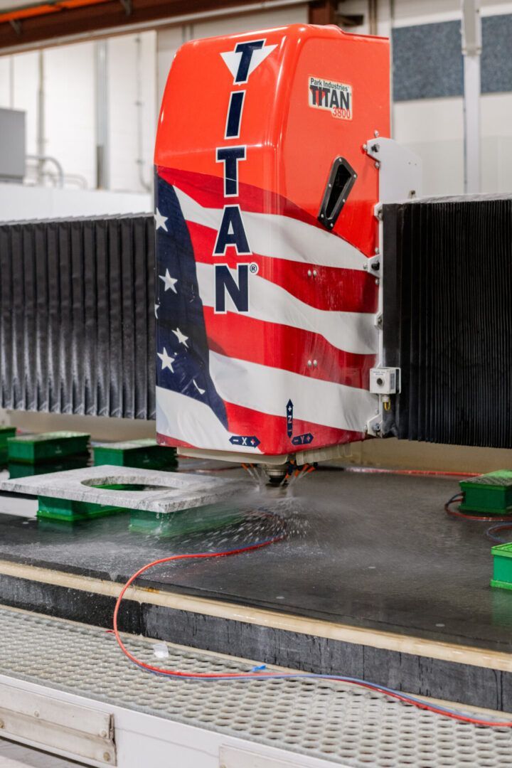 Red Titan truck cab crash-test dummy striking a padded barrier in a test facility