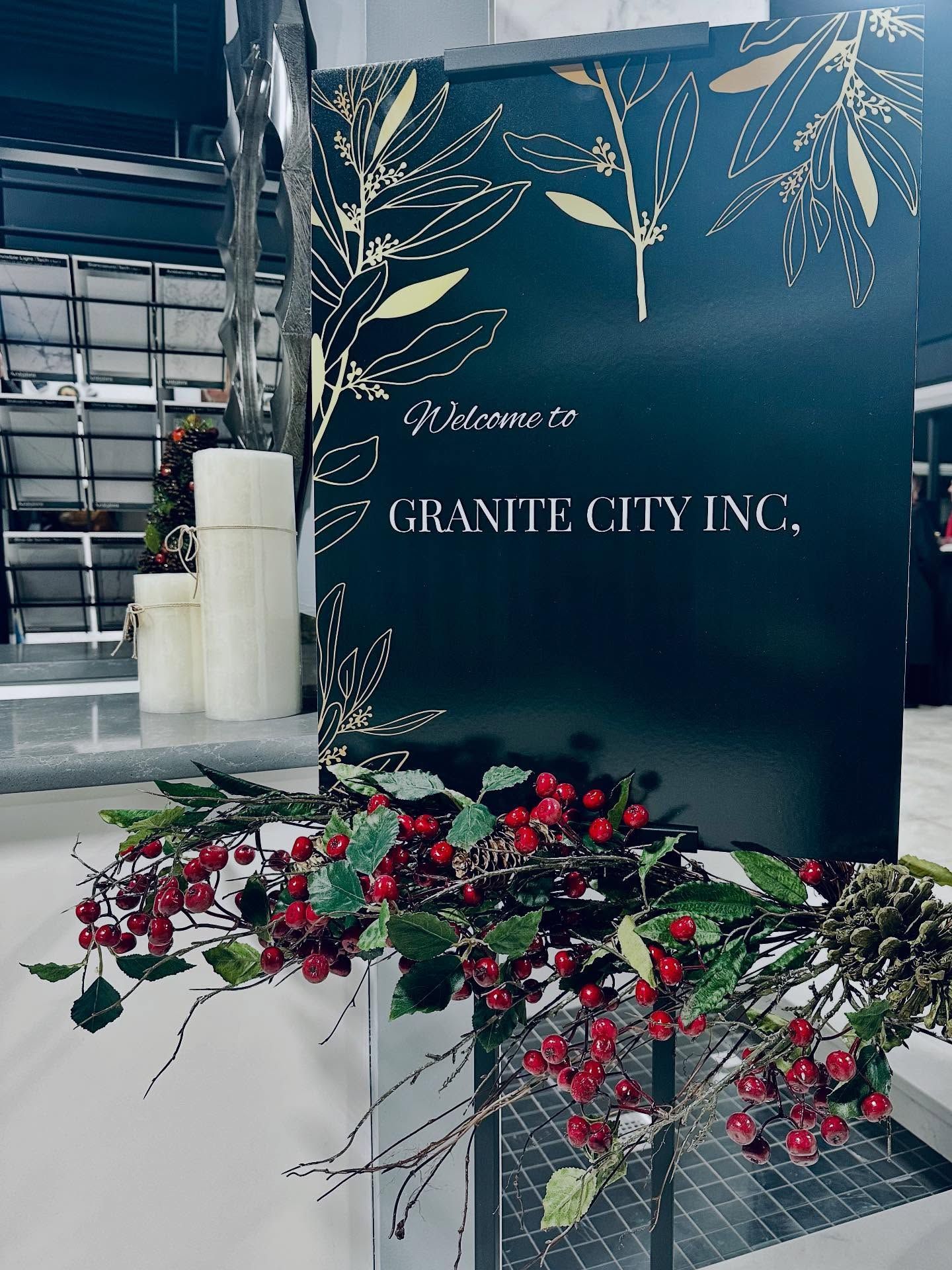 Floral arrangement beside a black Granite City Inc. sign in a warehouse setting
