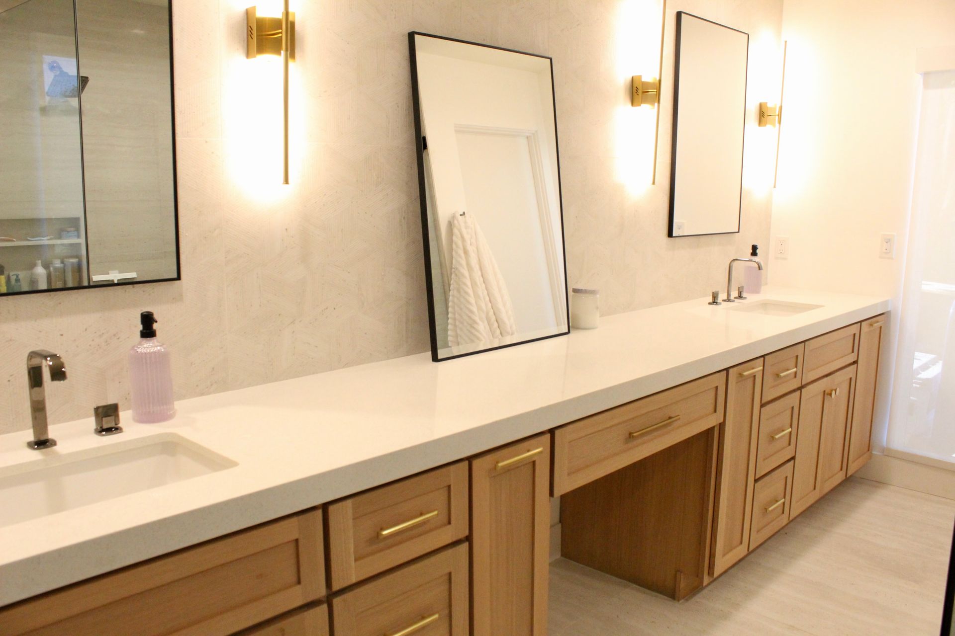 A bathroom with two sinks and two mirrors.