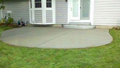There is a concrete patio in front of a house.