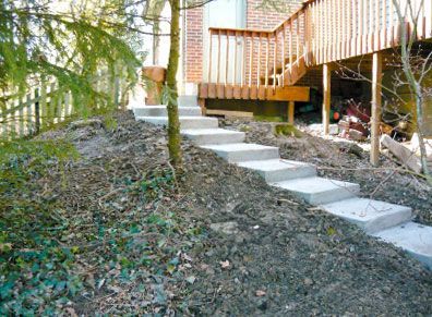 A set of concrete stairs leading up to a deck.