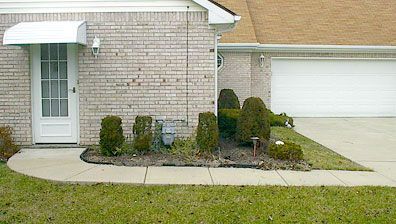 A brick house with a white door and a white awning