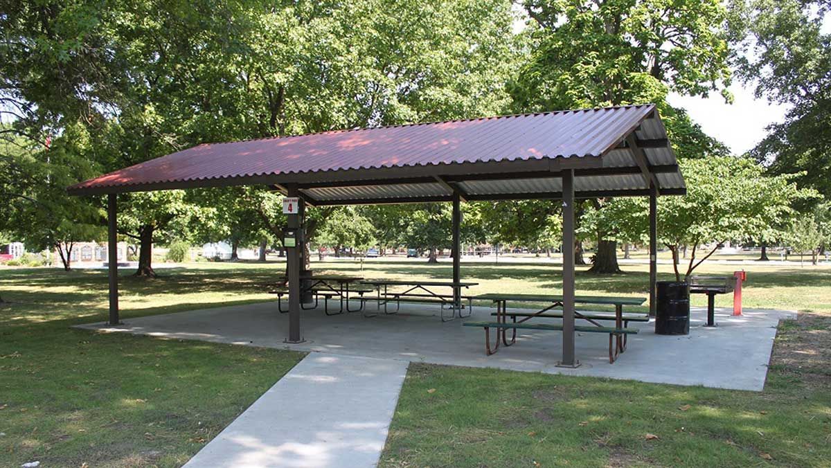 A picnic shelter with tables and benches in a park