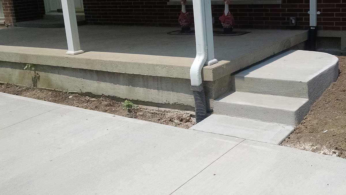 A brick house with a porch and steps