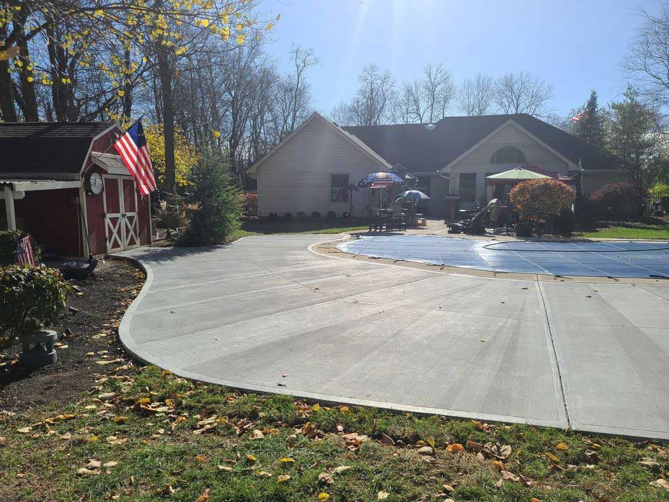 A large house with a swimming pool in front of it