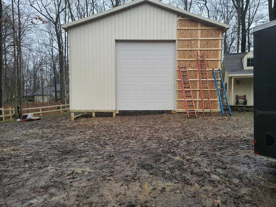 A garage door is being installed on the side of a building.