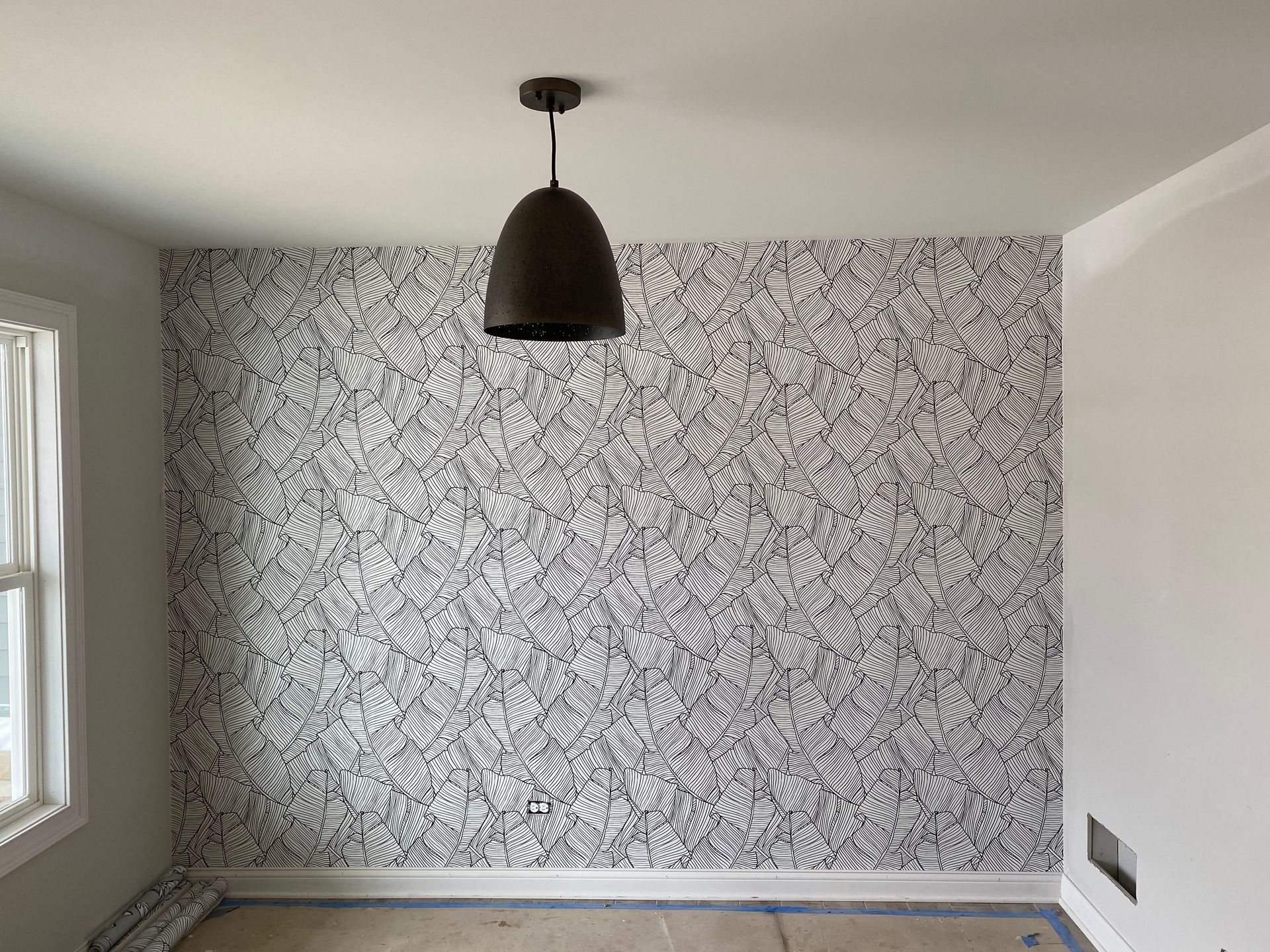 There is a light hanging from the ceiling in the room.