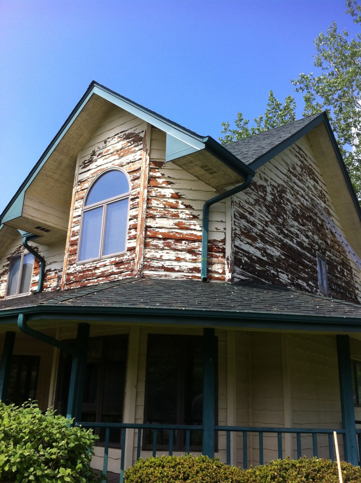 A house with a brick facade and a large window