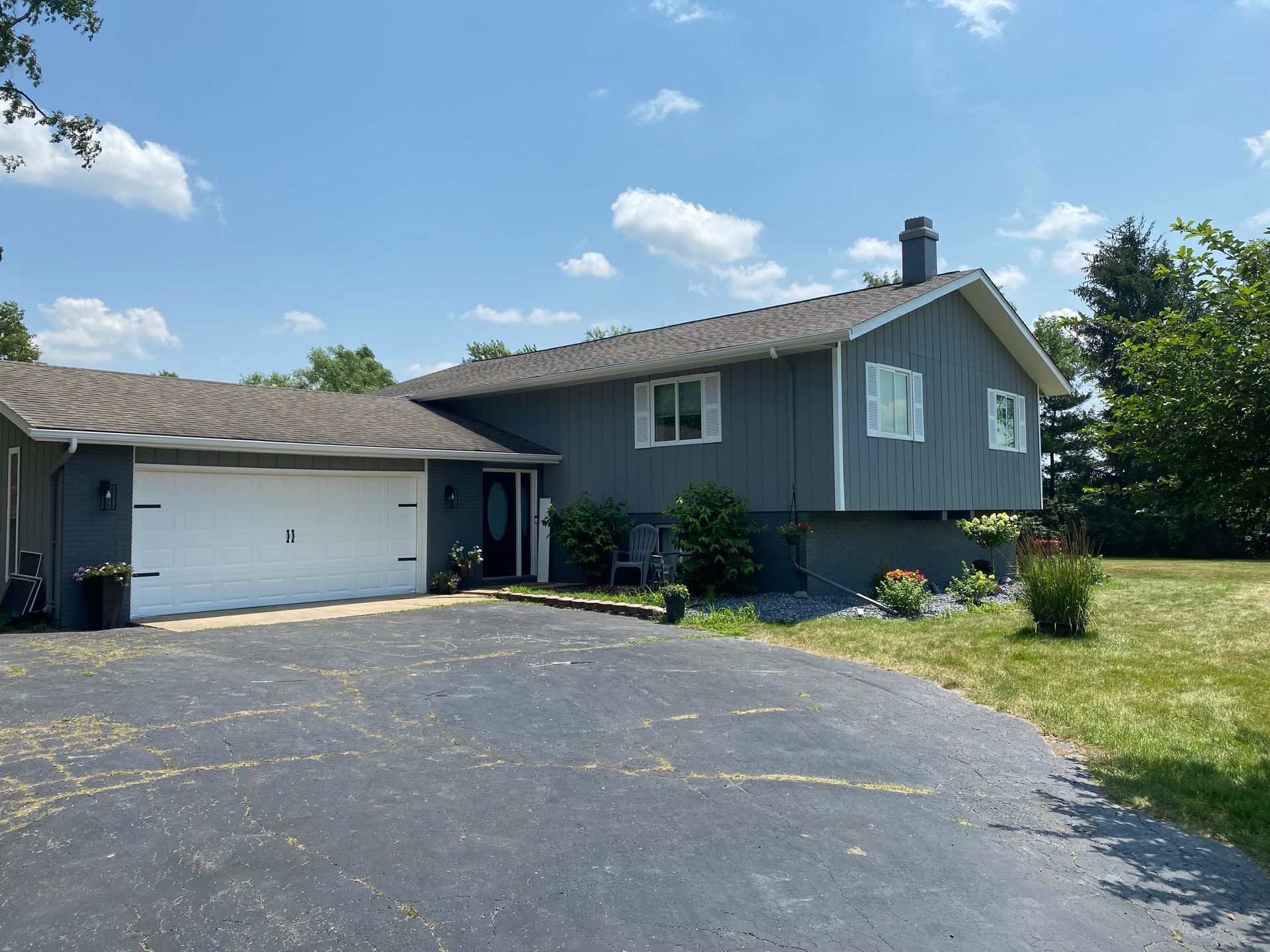 A house with a garage and a driveway in front of it