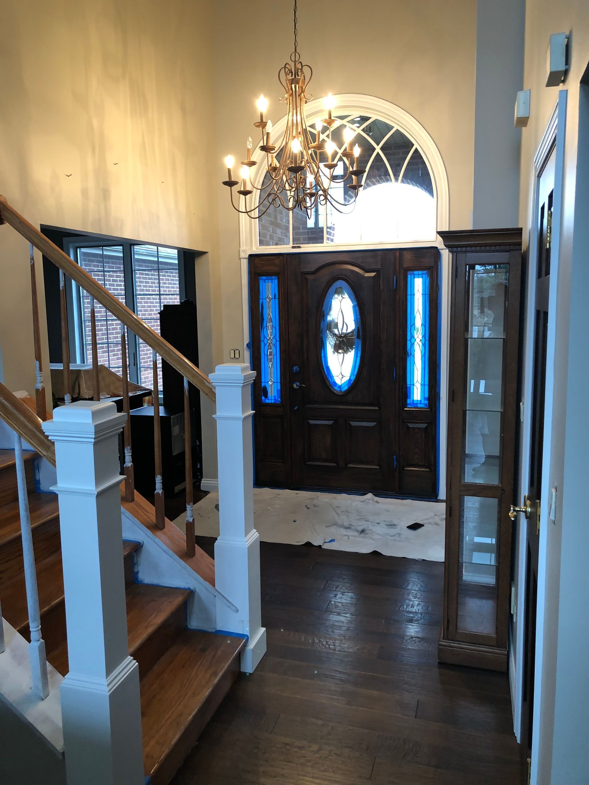 A hallway with stairs leading up to the front door