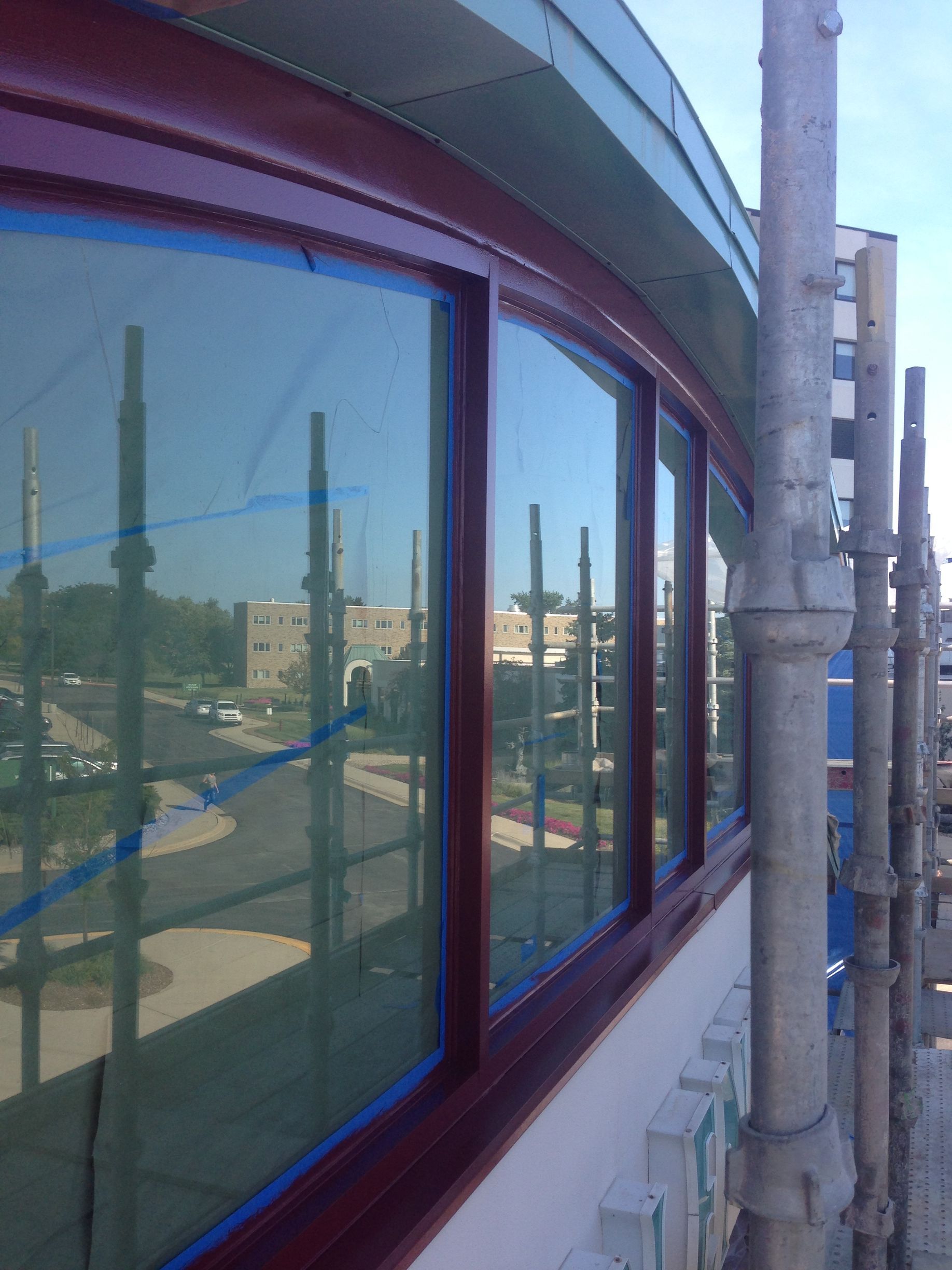 A building under construction with scaffolding around the windows