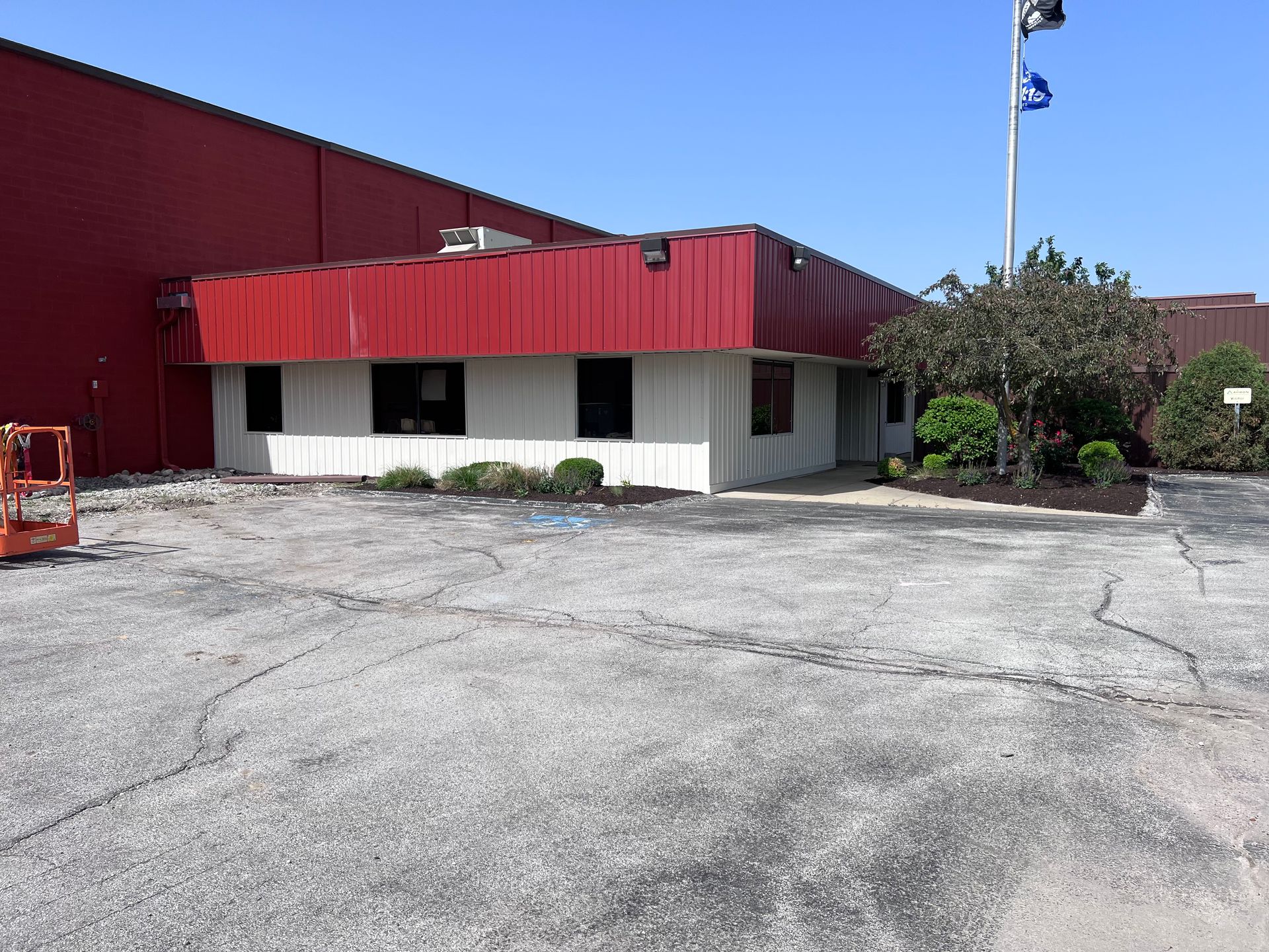 A building with a red roof and a white building with a red roof