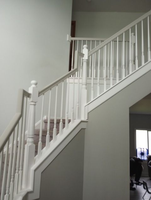 A staircase in a house with a white railing