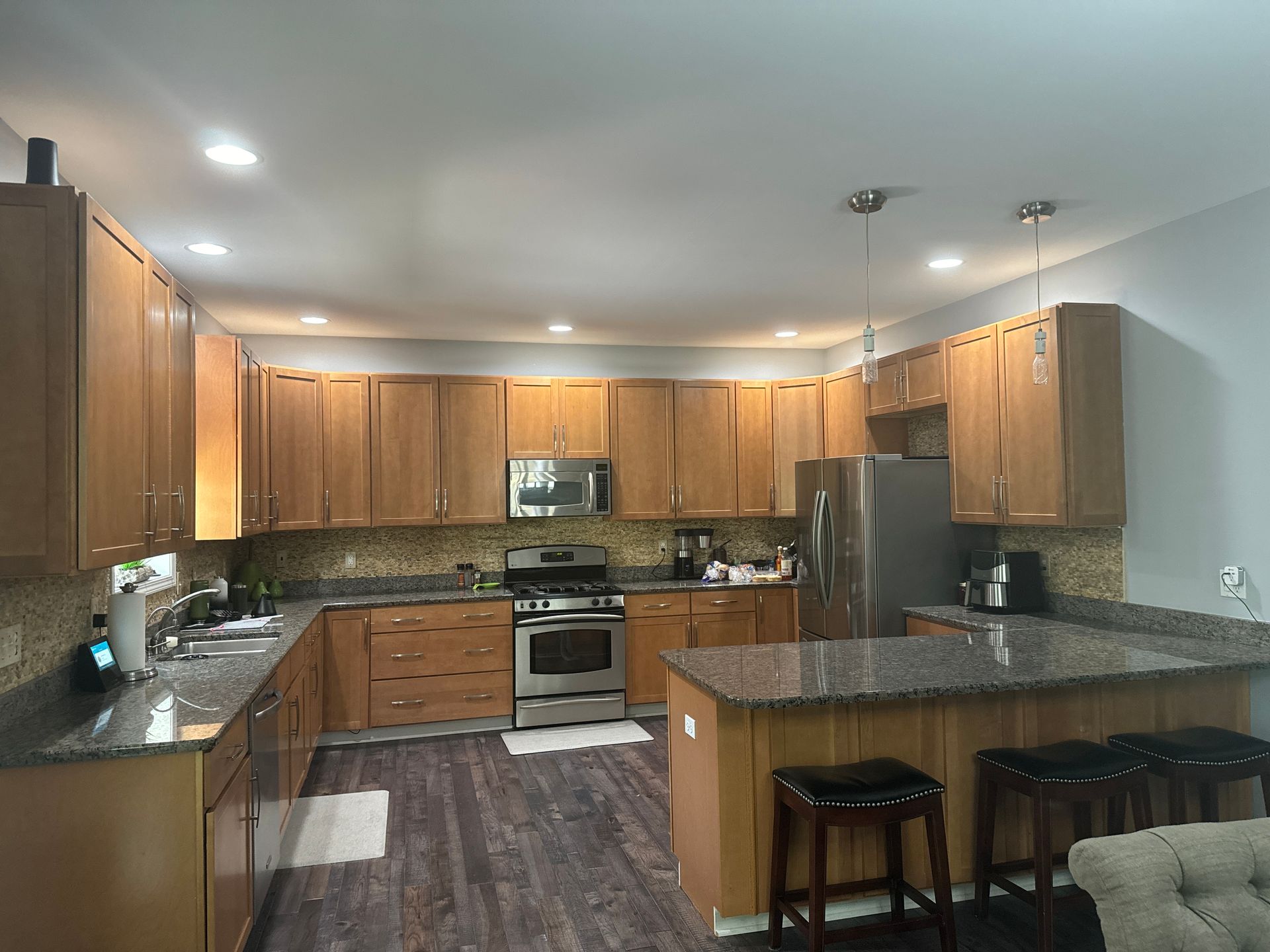 A kitchen with wooden cabinets and granite counter tops