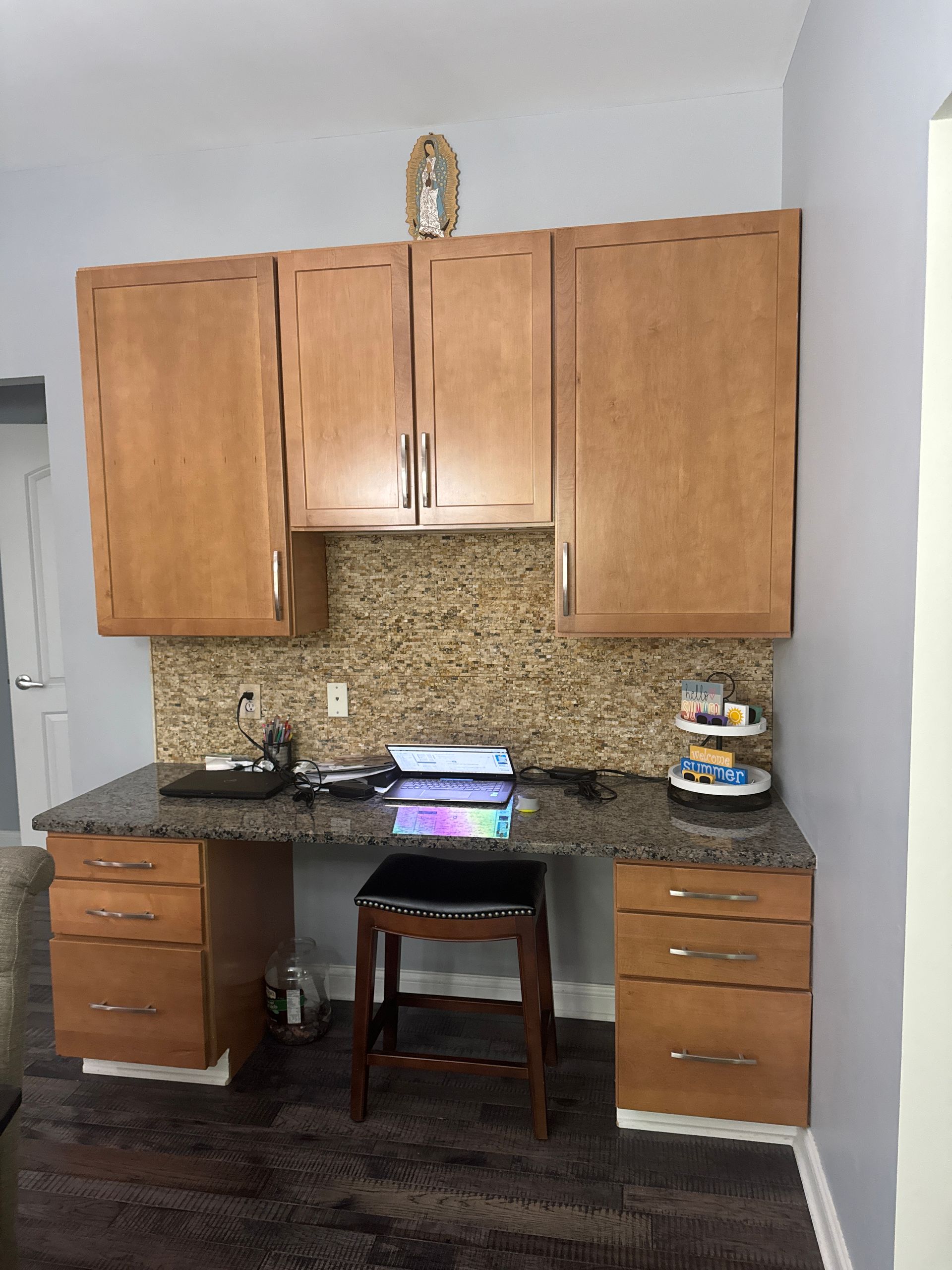 A kitchen with wooden cabinets and a granite counter top