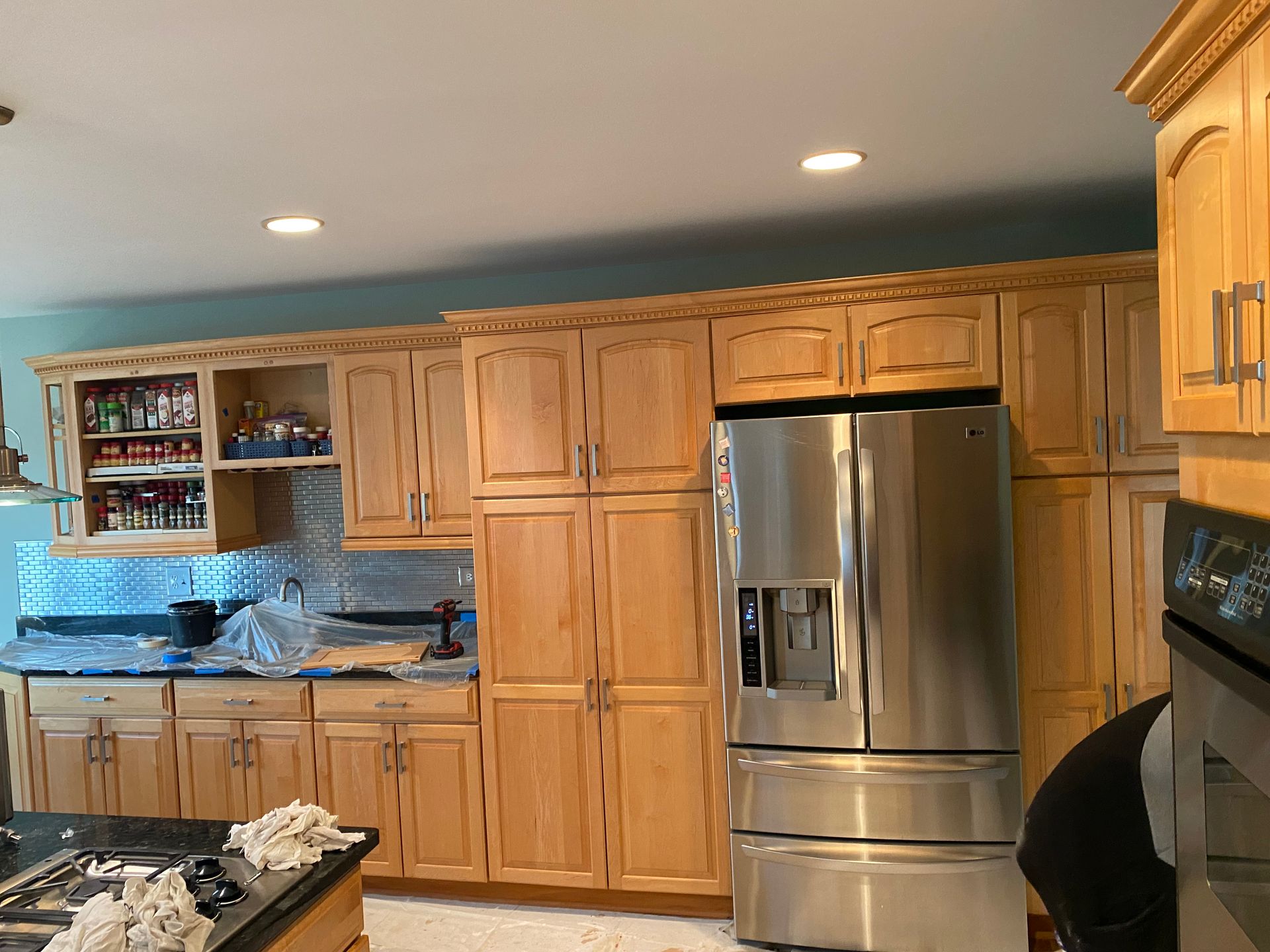 A kitchen with stainless steel appliances and wooden cabinets