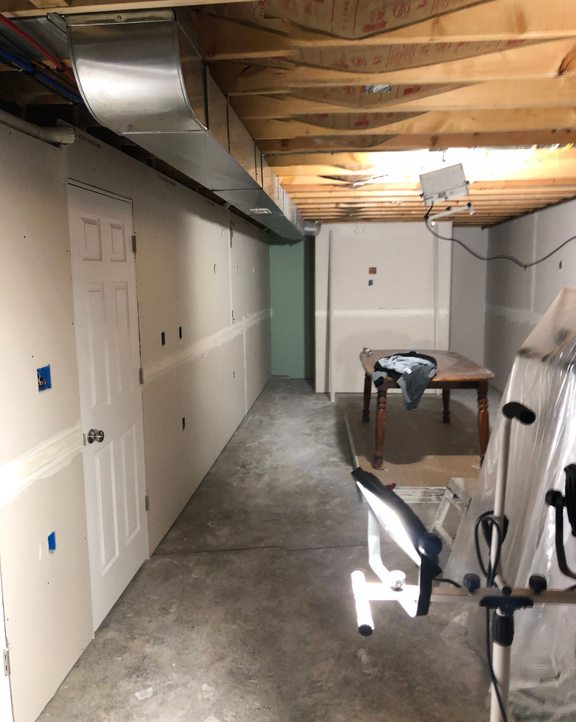 A long hallway with a table in the middle of it.