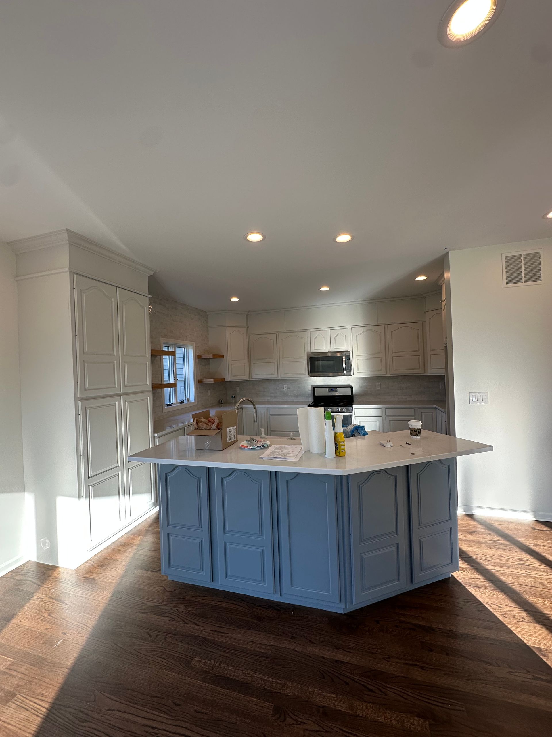 A kitchen with a large island in the middle of it.