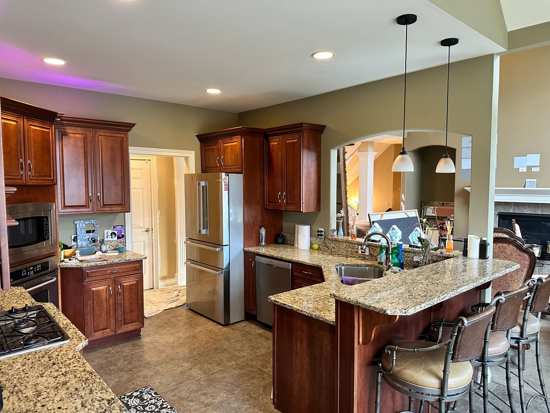 A kitchen with stainless steel appliances and granite counter tops.