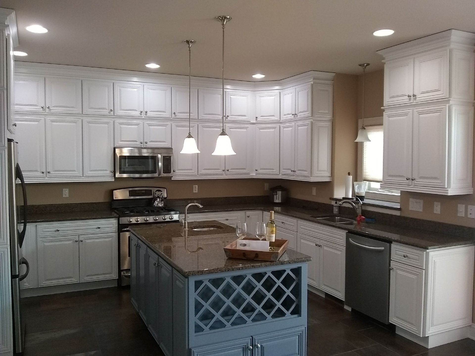 A kitchen with white cabinets and stainless steel appliances