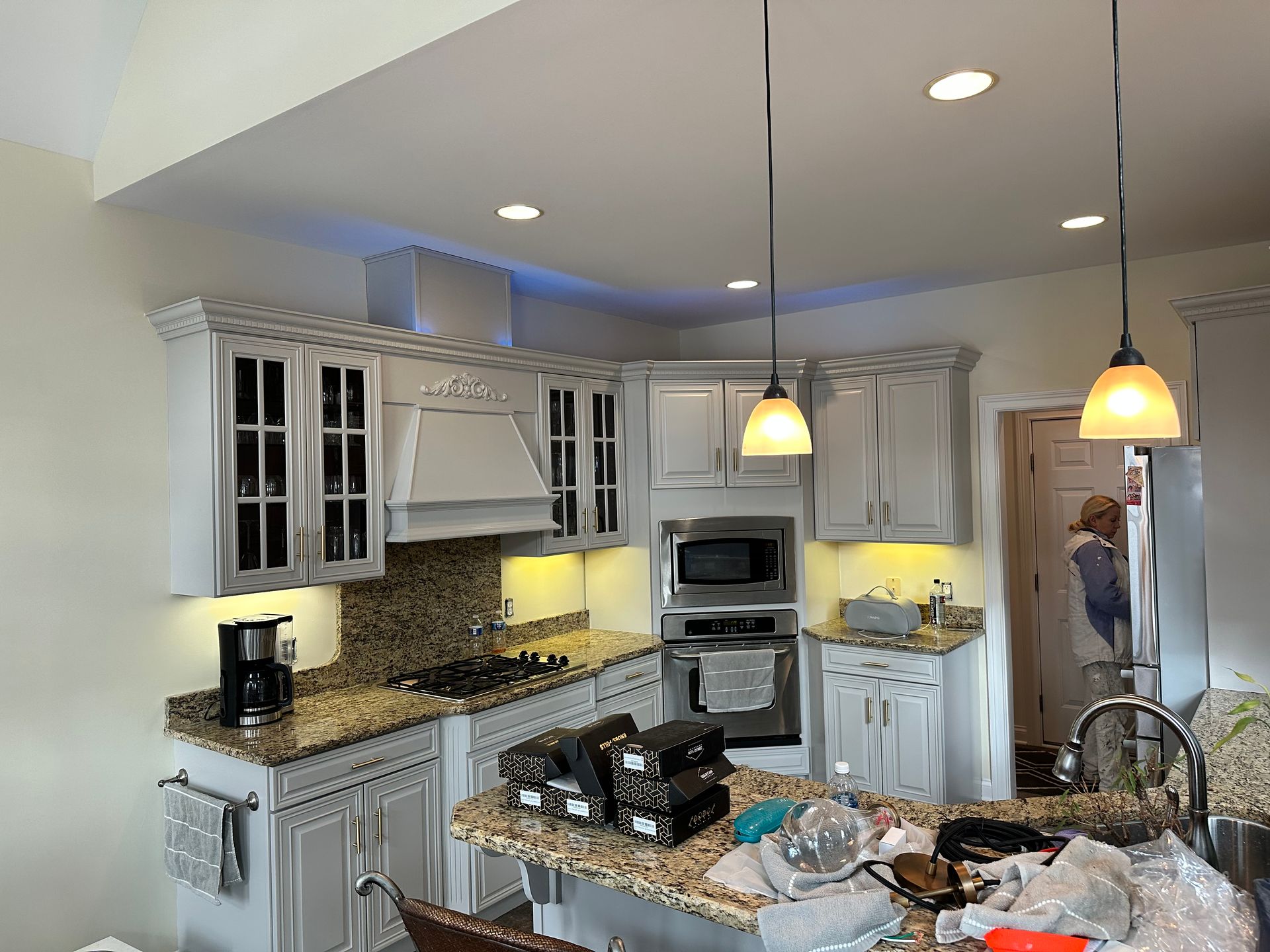 A kitchen with white cabinets and granite counter tops is being remodeled.