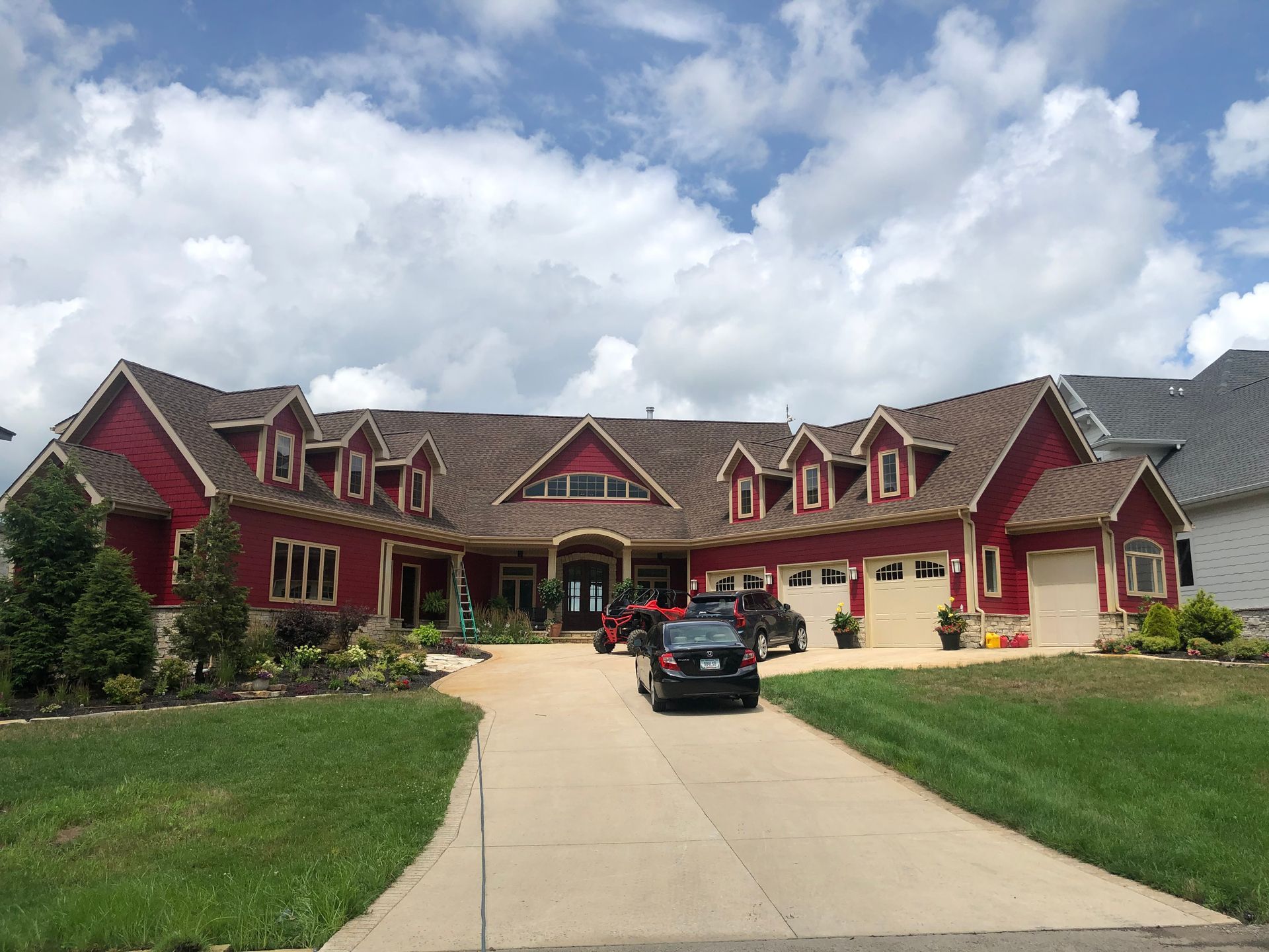 A large red house with a car parked in front of it.