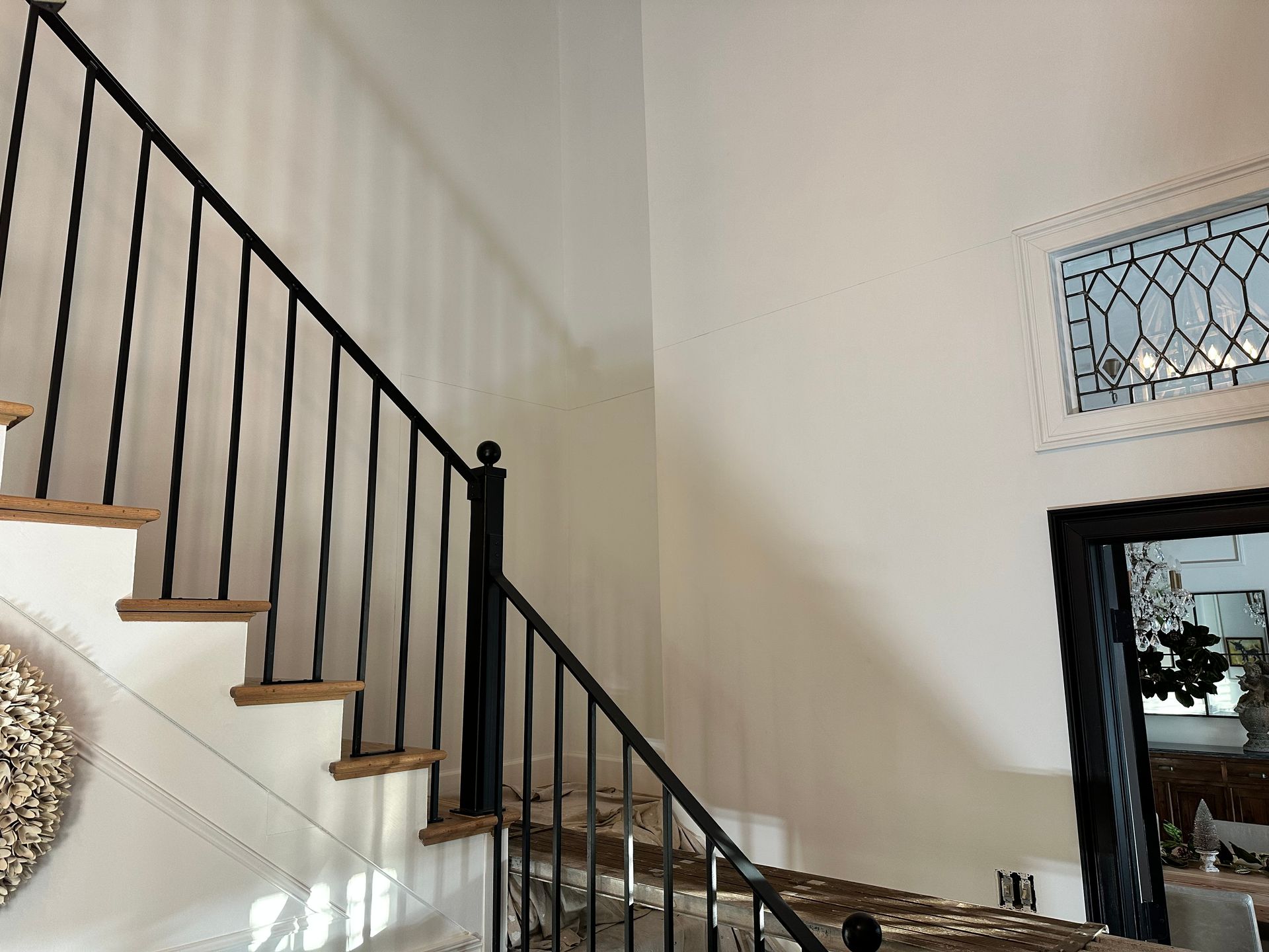 A staircase with a black railing and wooden steps
