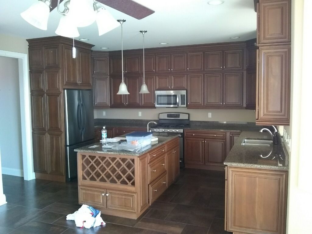 A kitchen with stainless steel appliances and wooden cabinets