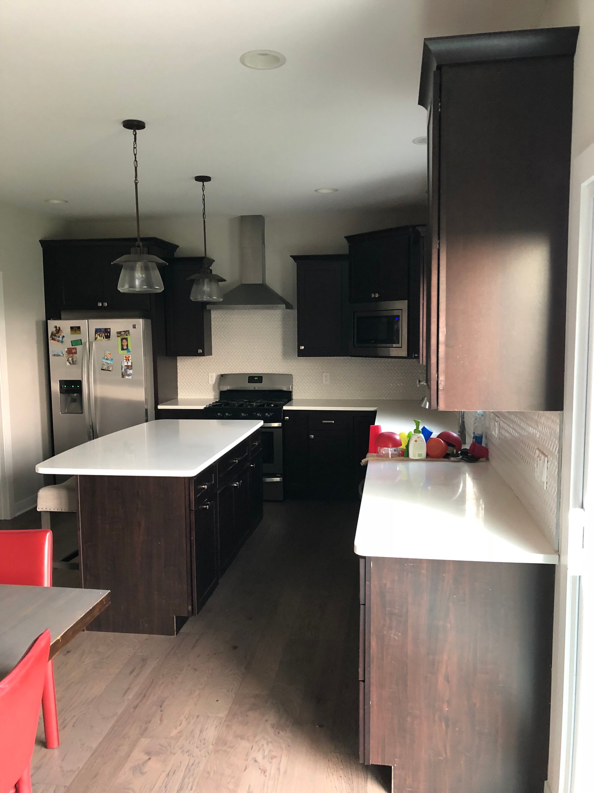 A kitchen with stainless steel appliances and wooden cabinets