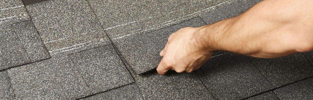 A person is repairing a leaky roof