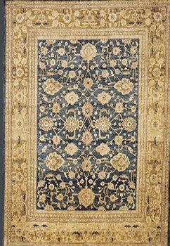 Blue and beige Oriental rug with floral and geometric patterns.