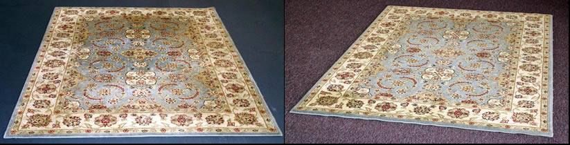 Two Persian rugs, one on a dark surface and one on a brown surface. Both rugs are light blue with floral designs.