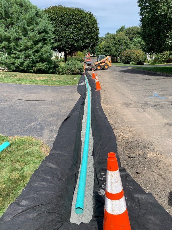 a drainage pipe is being installed in a driveway