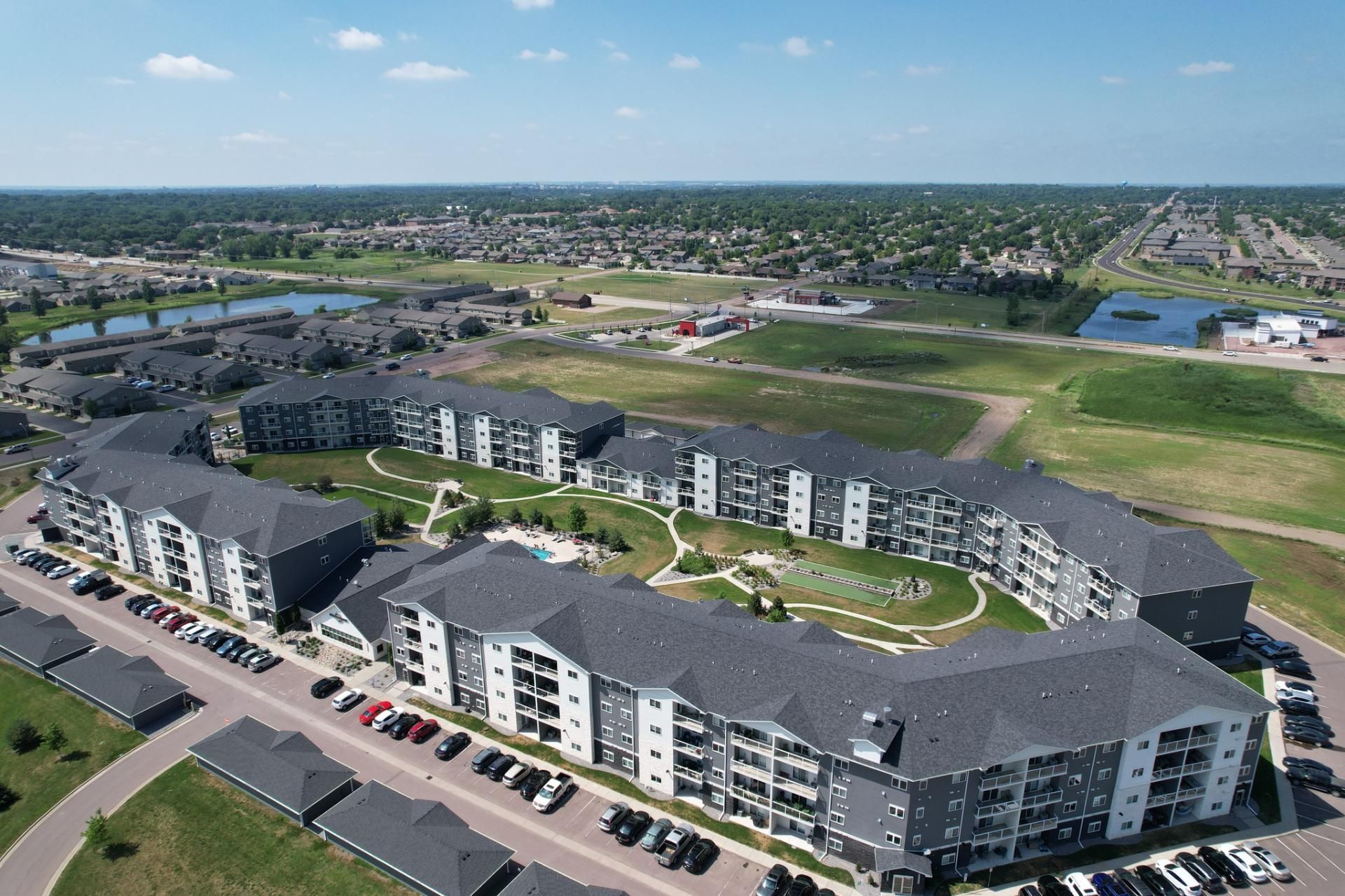 An aerial view of a large apartment complex in a residential area